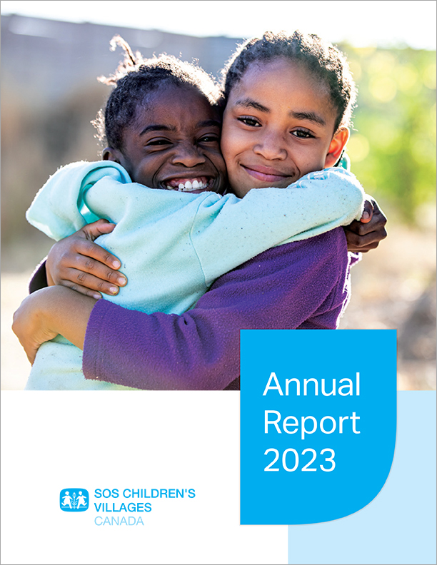 Cover of 2023 annual report, sisters hugging in Namibia.