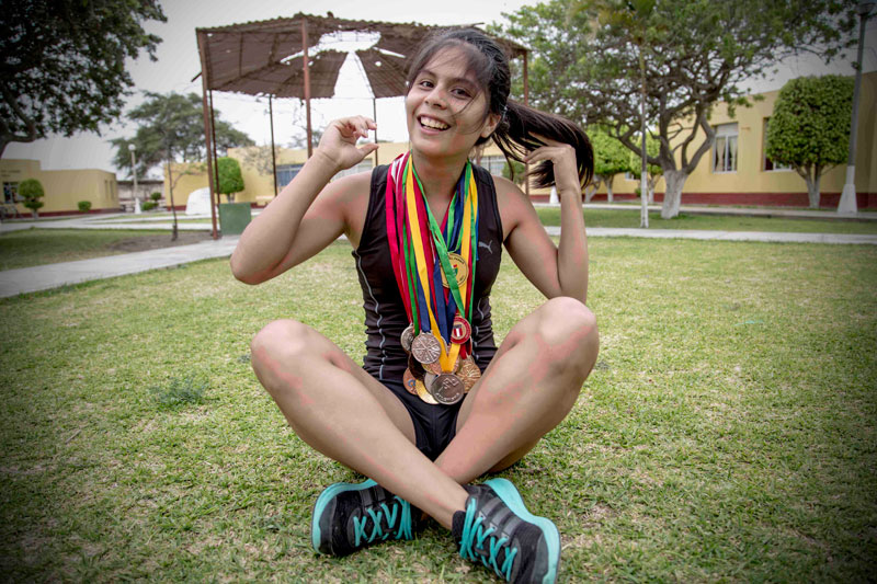 Camila a sprinter from Peru showing off her medals