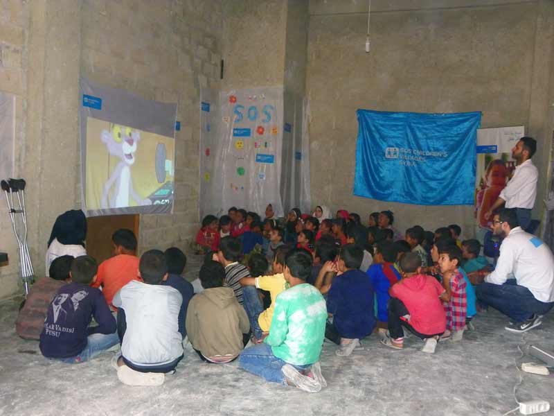 Children watching Pink Panther in temporary childcare places in Syria