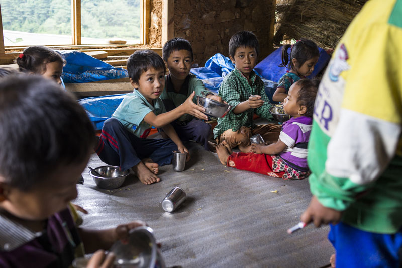 Children eating lunch an SOS Child Friendly Space in Rayale, Nepal