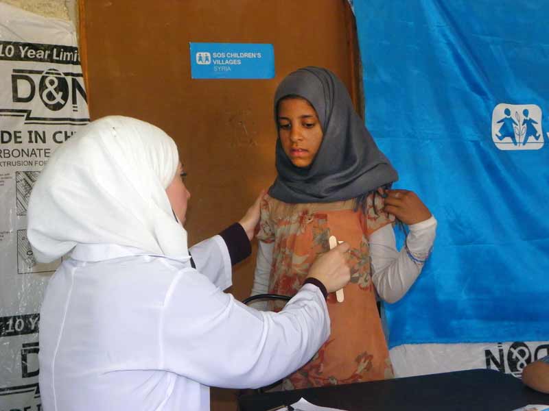 Girl being examined by doctor in Syria