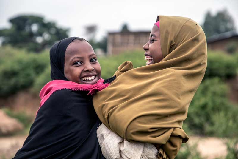 Two girls play in Gursum village