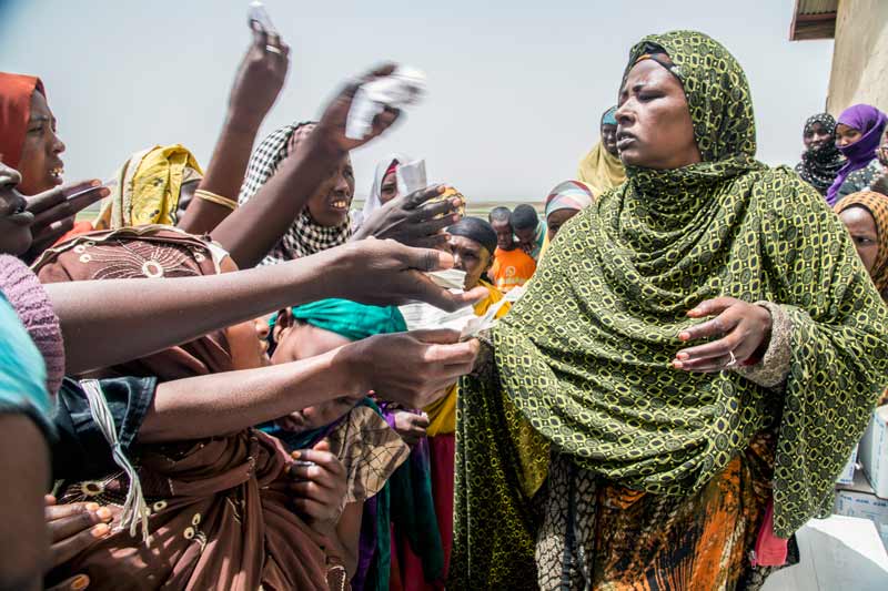 Desperate mothers present tickets for UN Food Aid