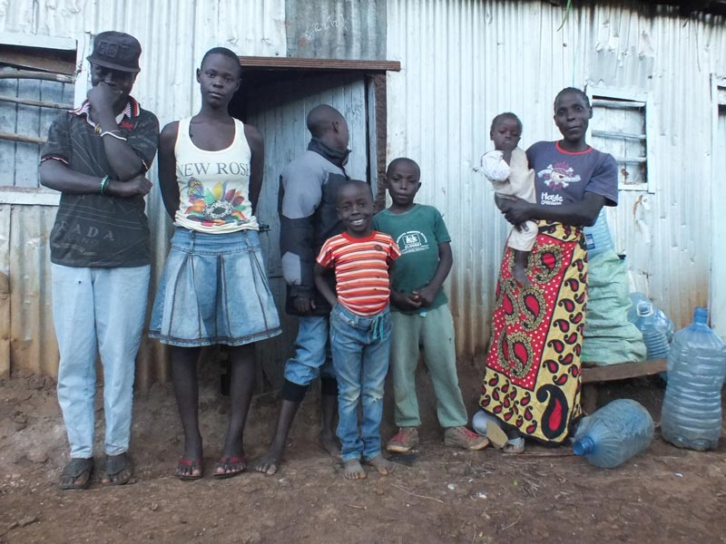 Noel and her six children outside their home