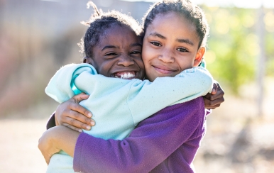 SOS Children’s Villages Namibia, two sisters hugging.