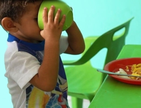 Child enjoying a nutritious meal in an SOS child-friendly space.